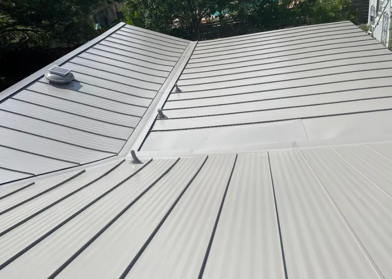 Solar attic fan installed on a metal roof for Roof Ventilation in Bonadelle Ranchos